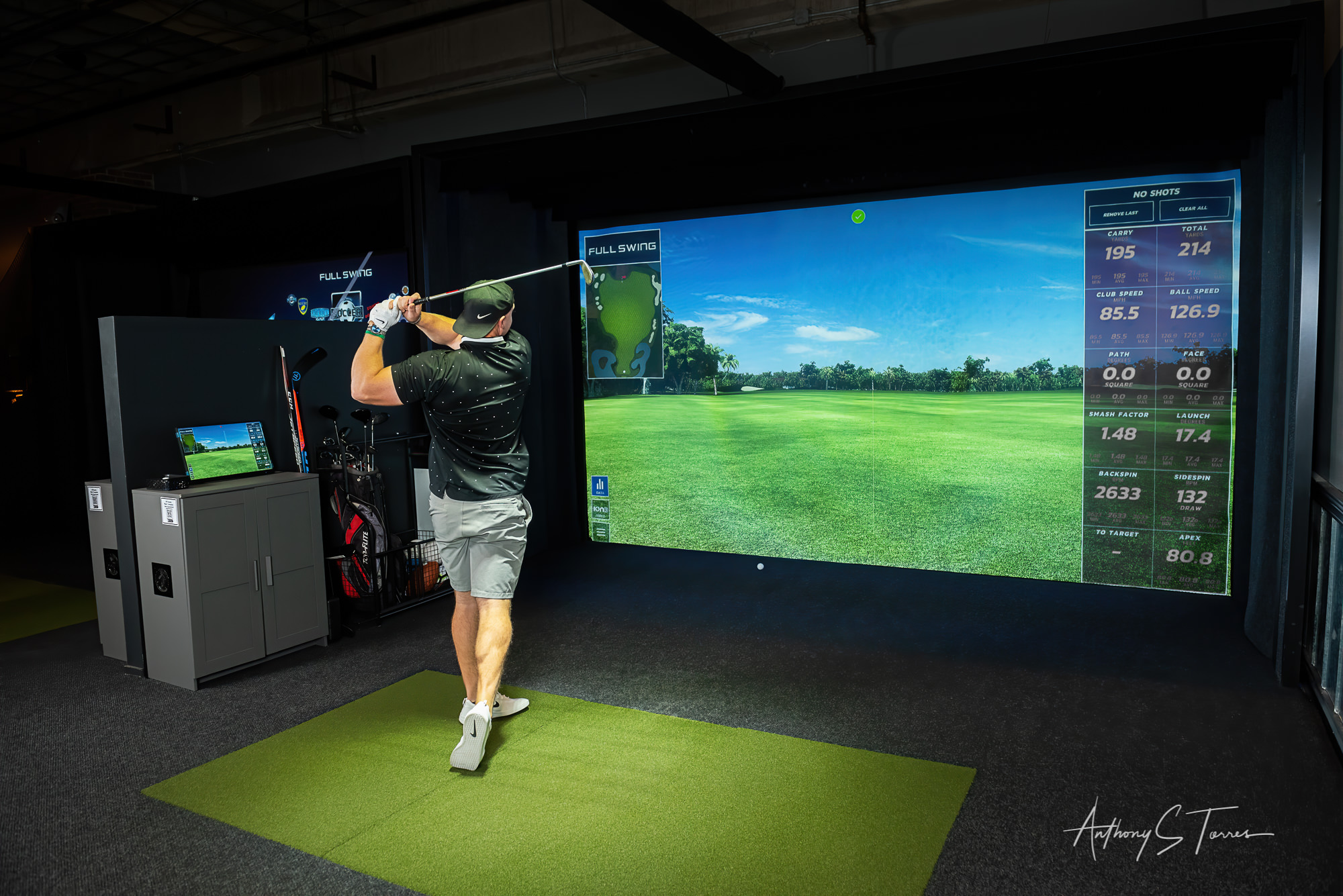 Golfer swinging on simulator, Brookfields Indoor Golf Lounge, Wake Forest NC
